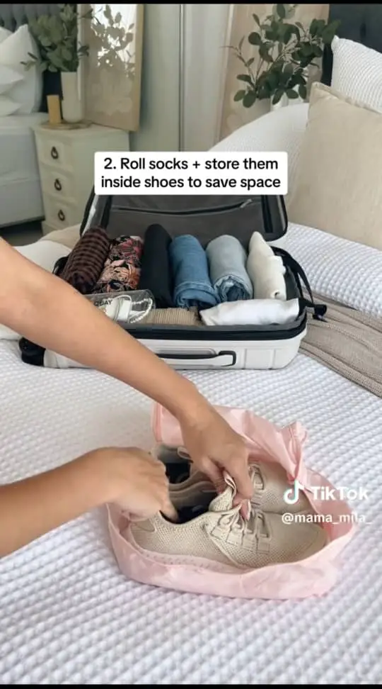Travel bag maximizes space by rolling socks into shoes